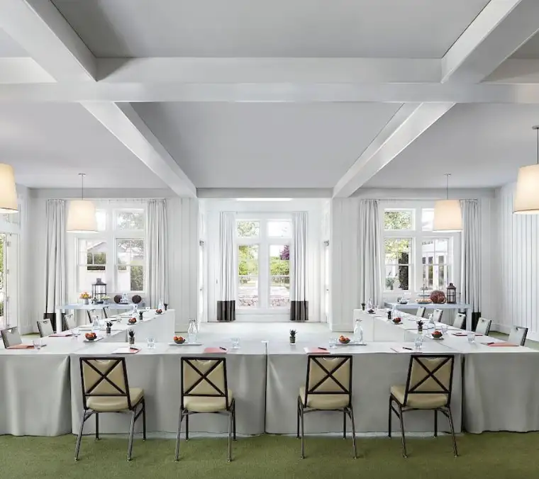 Sonoma Hall laid out in a U-shape, white beamed ceiling and french doors to the garden.
