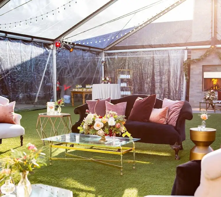 The Carneros Courtyard under a clear-roofed tent, with sofas, low tables and a fireplace.